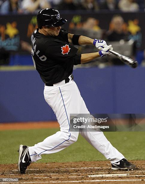 John McDonald of the Toronto Blue Jays hits against the Los Angeles Angels during a MLB game at the Rogers Centre April 17, 2010 in Toronto, Ontario,...