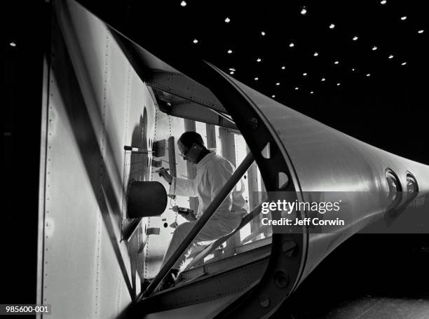 aviation engineer undertaking wing structural inspection (b&w) - boeing stock pictures, royalty-free photos & images