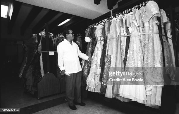 Filipino government investigator Jovita Salonga examines clothing of Emelda Marcos at Malacanang Palace during his investigation of the former...