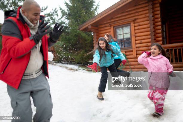 throwing snowballs at their father - snowball stock pictures, royalty-free photos & images