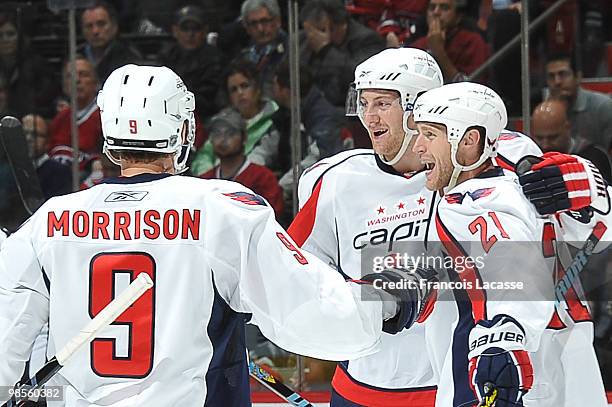 Brendan Morrison of the Washington Capitals celebrates a goal with teammate Brooks Laich and teammate Eric Fehr in the Game Three of the Eastern...