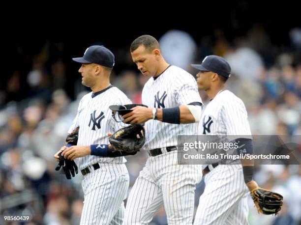 Derek Jeter, Alex Rodriguez and Robinson Cano of the New York Yankees walk to their positons against the Texas Rangers against the New York Yankees...