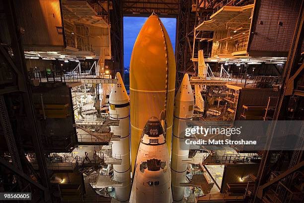 Space Shuttle Atlantis prepares to roll out of NASA's vehicle assembly atop a crawler transporter to launch pad 39-a at Kennedy Space Center on April...