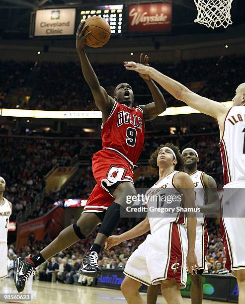 Luol Deng of the Chicago Bulls gets a shot off next to Anderson Varejao and Zydrunas Ilgauskas of the Cleveland Cavaliers in Game Two of the Eastern...