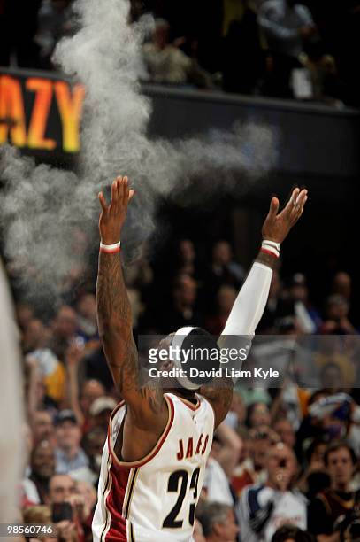 LeBron James of the Cleveland Cavaliers tosses talc powder high into the air moments before tipoff against the Chicago Bulls in Game Two of the...