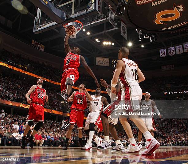 Luol Deng of the Chicago Bulls dunks the ball surrounded by Shaquille O'Neal, LeBron James and Anthony Parker of the Cleveland Cavaliers in Game Two...