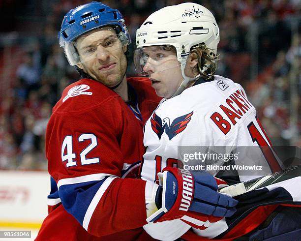 Dominic Moore of the Montreal Canadiens and Nicklas Backstrom of the Washington Capitals collide in Game Three of the Eastern Conference...