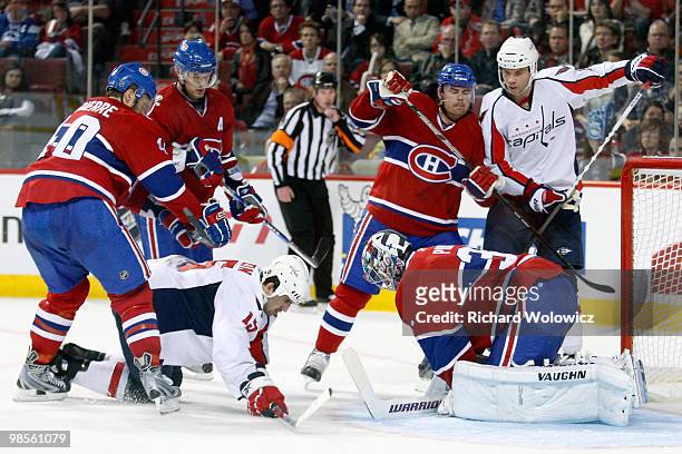 Carey Price of the Montreal Canadiens covers up the loose puck in front of Boyd Gordon of the Washington Capitals in Game Three of the Eastern...