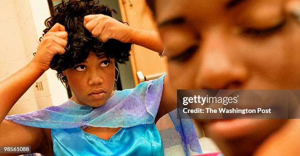 Charles Herbert Flowers high school's Madison Sellers adjusted her wig as Akeira Cramer had make-up applied before the start of a dress rehearsal of...
