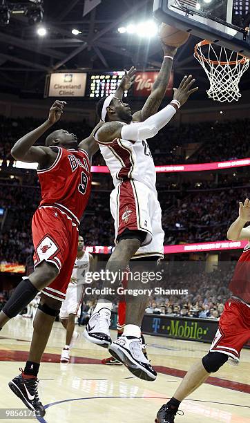 LeBron James of the Cleveland Cavaliers tries to gets to the basket between Luol Deng and Brad Miller of the Chicago Bulls in Game Two of the Eastern...