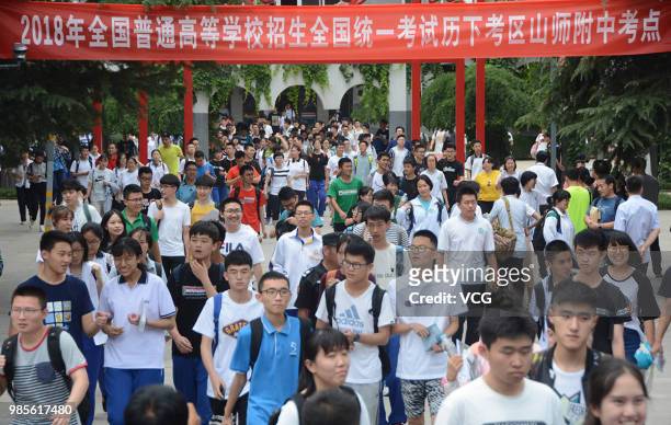 Candidates walk out of an exam site after finishing their first subject during the National College Entrance Examination on June 7, 2018 in Jinan,...