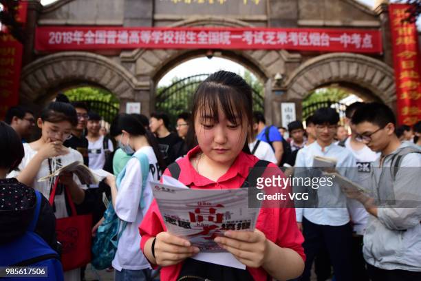 Candidates review before entering an exam site for the National College Entrance Examination at Yantai No.1 Middle School on June 7, 2018 in Yantai,...