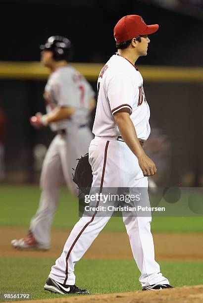 Starting pitcher Rodrigo Lopez of the Arizona Diamondbacks reacts after giving up a three-run home run to Matt Holliday of the St. Louis Cardinals...