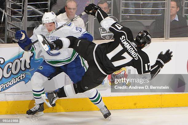 Wayne Simmonds of the Los Angeles Kings is checked by Alexander Edler of the Vancouver Canucks in Game Three of the Western Conference Quarterfinals...