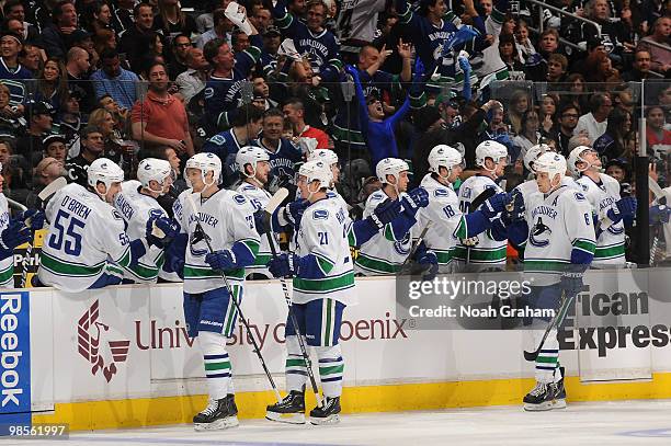 Mason Raymond and Sami Salo of the Vancouver Canucks celebrate with the bench after a goal against the Los Angeles Kings in Game Three of the Western...