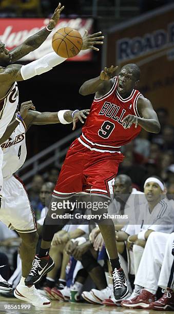 Luol Deng of the Chicago Bulls passes around LeBron James and Antawn Jamison of the Cleveland Cavaliers in Game Two of the Eastern Conference...