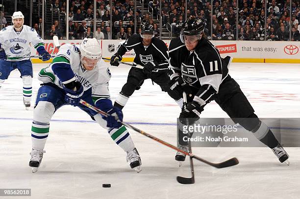 Anze Kopitar of the Los Angeles Kings reaches for the puck against Christian Ehrhoff of the Vancouver Canucks in Game Three of the Western Conference...
