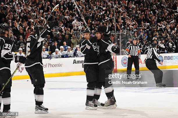 Drew Doughty of the Los Angeles Kings celebrates with teammates Michal Handzus and Jack Johnson after scoring a goal against the Vancouver Canucks in...