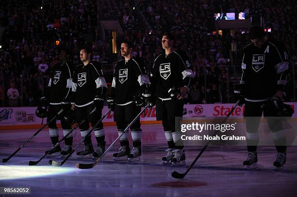 Wayne Simmonds, Drew Doughty, Rob Scuderi, Ryan Smyth and Anze Kopitar of the Los Angeles Kings stand on the ice prior to taking on the Vancouver...