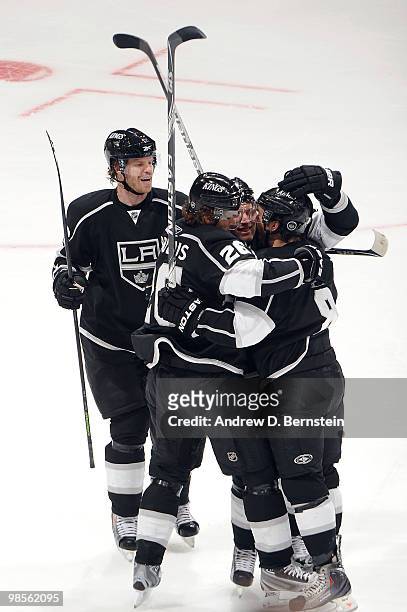 Drew Doughty of the Los Angeles Kings celebrates with Fredrik Modin, Michal Handzus and Jack Johnson after scoring a goal against the Vancouver...