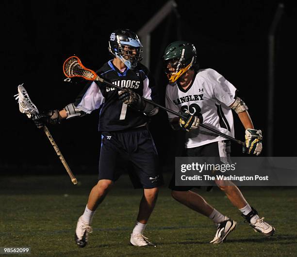 Stone Bridge's Derek Maltz, L, tries to work his way around Langley's Thomas Robinson during a lacrosse game between Langley High School and Loundoun...