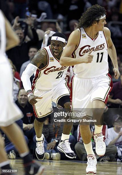 LeBron James of the Cleveland Cavaliers reacts after a first quarter dunk behind Anderson Varejao while playing the Chicago Bulls in Game Two of the...