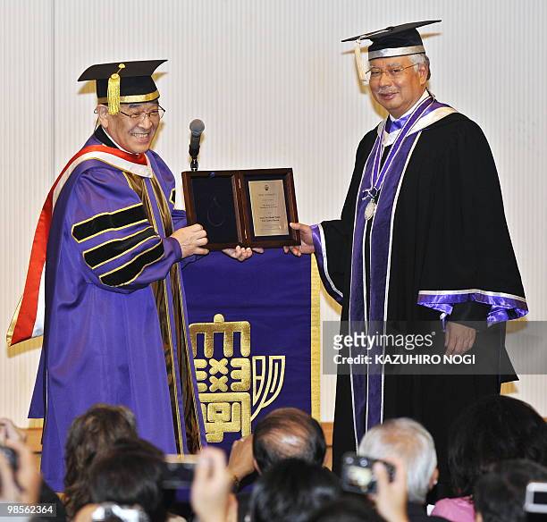 Malaysian Prime Minister Najib Razak receives an honorary doctorate from Hiromi Naya, president of Meiji University during a conferment ceremony in...