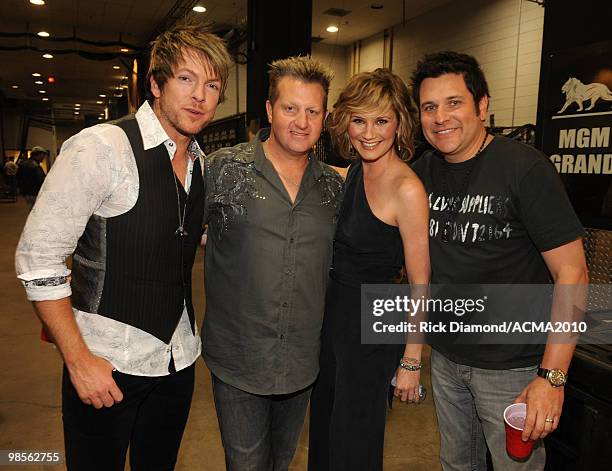 Musicians Joe Don Rooney, Gary LeVox, and Jay DeMarcus of Rascal Flatts with Jennifer Nettle of Sugarland pose backstage during Brooks & Dunn's The...