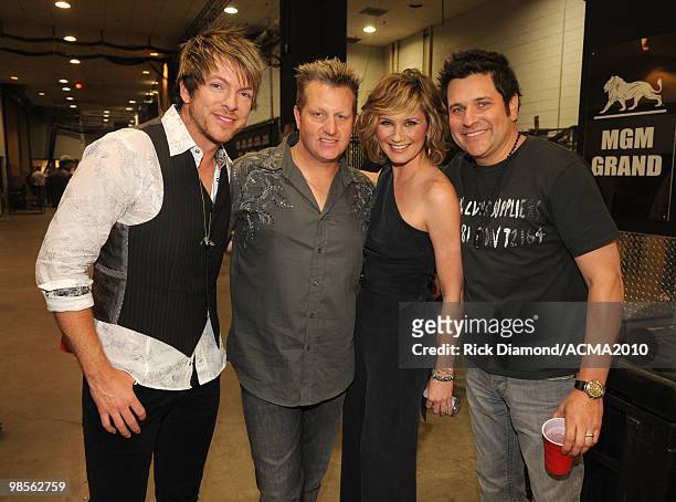Musicians Joe Don Rooney, Gary LeVox, and Jay DeMarcus of Rascal Flatts with Jennifer Nettle of Sugarland pose backstage during Brooks & Dunn's The...