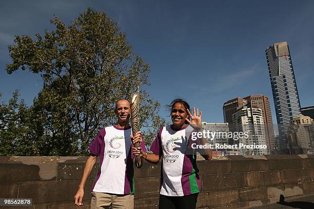 Steve Moneghetti and Cathy Freeman pose for a photo with the baton as part of the Delhi 2010 Commonwealth Games Queen's Baton relay along the Yarra...