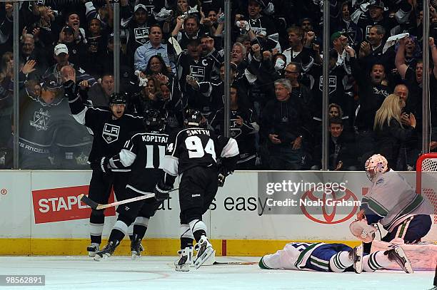 Michal Handzus of the Los Angeles Kings celebrates with teammates Anze Kopitar and Ryan Smyth after scoring a goal against the Vancouver Canucks in...