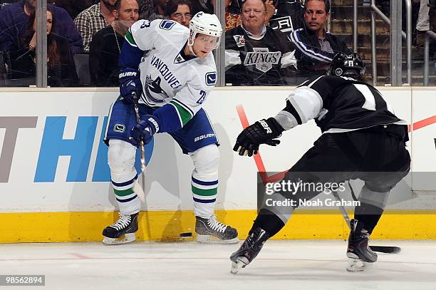 Alexander Edler of the Vancouver Canucks passes the puck against Anze Kopitar of the Los Angeles Kings in Game Three of the Western Conference...