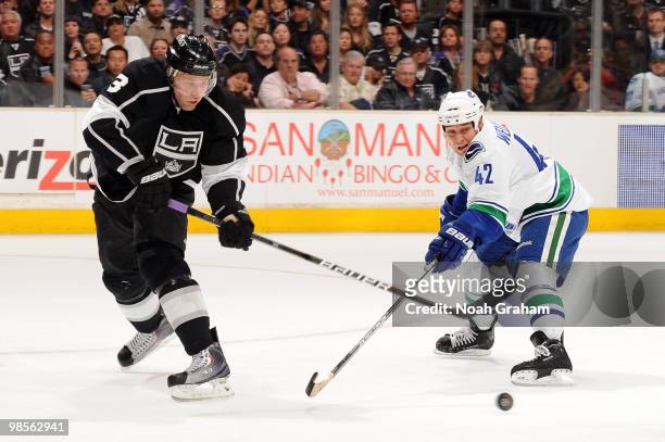 Jack Johnson of the Los Angeles Kings battles for the puck against Kyle Wellwood of the Vancouver Canucks in Game Three of the Western Conference...