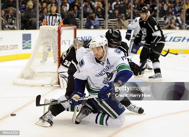 Ryan Kesler of the Vancouver Canucks shoot the puck behind his back as he is followed by Anze Kopitar of the Los Angeles Kings during the third...