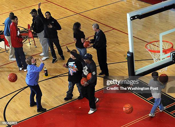 December 29, {year}: MORE THAN A GAME Nancy Carter, left, gets a high five after sinking a basket in the Hot Shot competition during the finas of the...