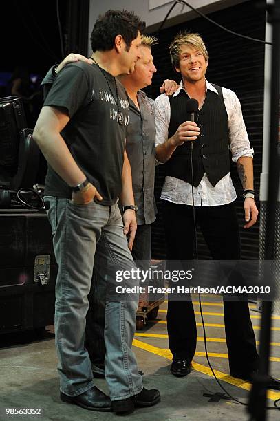 Musicians Jay DeMarcus, Gary LeVox and Joe Don Rooney of Rascal Flatts speak backstage during Brooks & Dunn's The Last Rodeo Show at the MGM Grand...