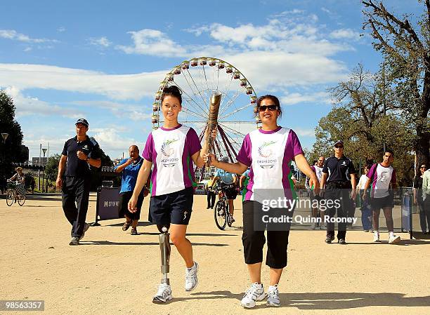 Australian athlete Kelly Cartwright and Manpreet Singh carry the baton as part of the Delhi 2010 Commonwealth Games Queen's Baton relay at Birrarung...