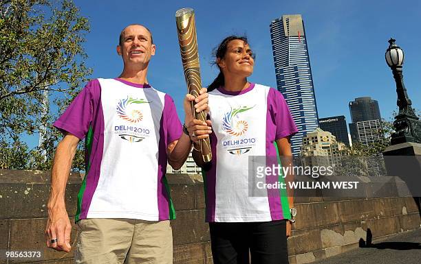 Legendary Australian Olympic and Commonwealth Games runners Steve Moneghetti and Cathy Freeman hold the baton aloft as the Queen's Baton Relay makes...