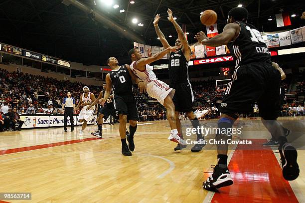 Will Conroy of the Rio Grande Valley Vipers passes the ball while being surrounded by Curtis Jerrells, Eddie Basden, and Lewis Clinch of the Austin...