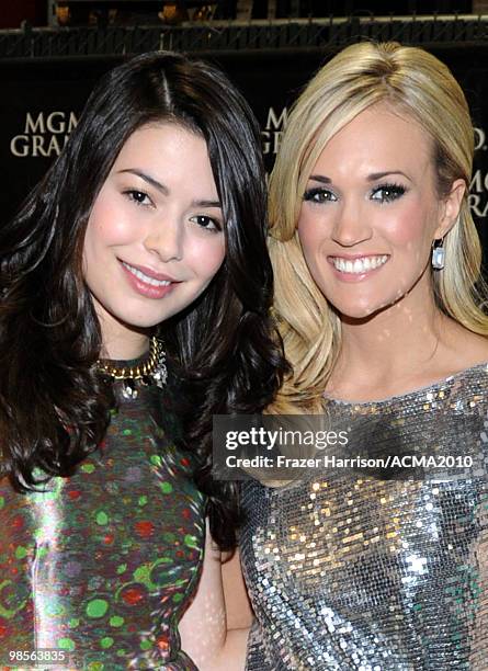 Actress Miranda Cosgrove and musician Carrie Underwood pose backstage during Brooks & Dunn's The Last Rodeo Show at the MGM Grand Garden Arena on...