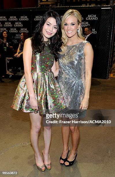 Actress Miranda Cosgrove and musician Carrie Underwood pose backstage during Brooks & Dunn's The Last Rodeo Show at the MGM Grand Garden Arena on...