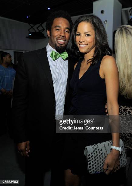 Professional Football Player Dhani Jones and model Veronica Webb pose for a photo at the exclusive viewing party for "Dhani Tackles The Globe" at Red...