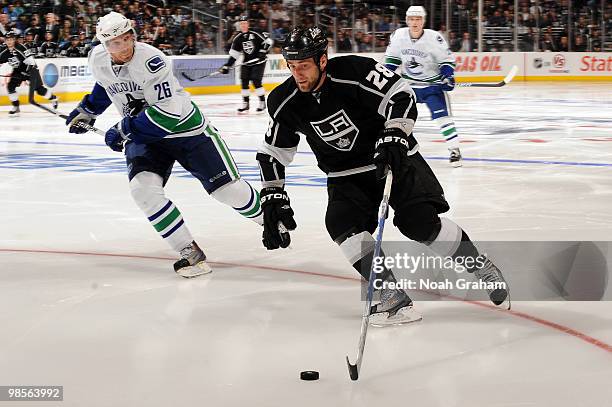 Jarret Stoll of the Los Angeles Kings skates with the puck against the Vancouver Canucks in Game Three of the Western Conference Quarterfinals during...