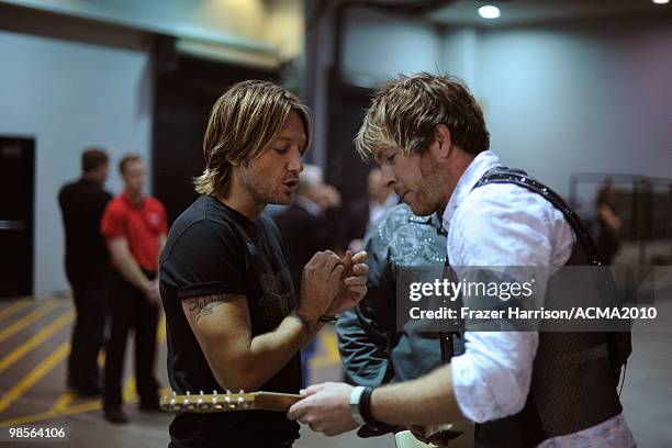 Musicians Keith Urban, Gary LeVox and Joe Don Rooney speak backstage during Brooks & Dunn's The Last Rodeo Show at the MGM Grand Garden Arena on...