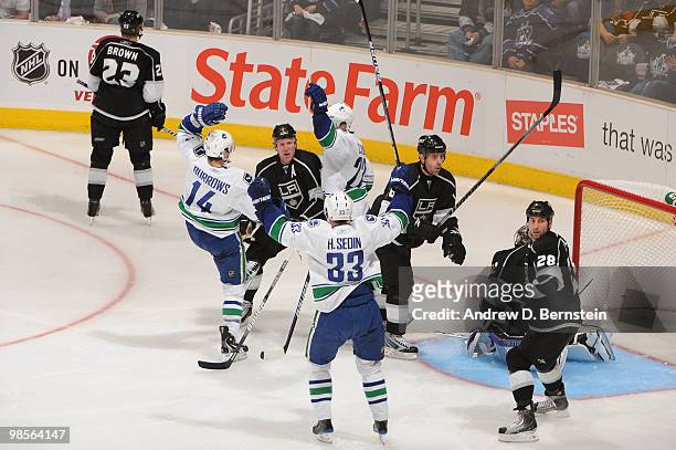 Alexandre Burrows, Henrik Sedin and Daniel Sedin of the Vancouver Canucks celebrate after scoring a goal against the Los Angeles Kings in Game Three...