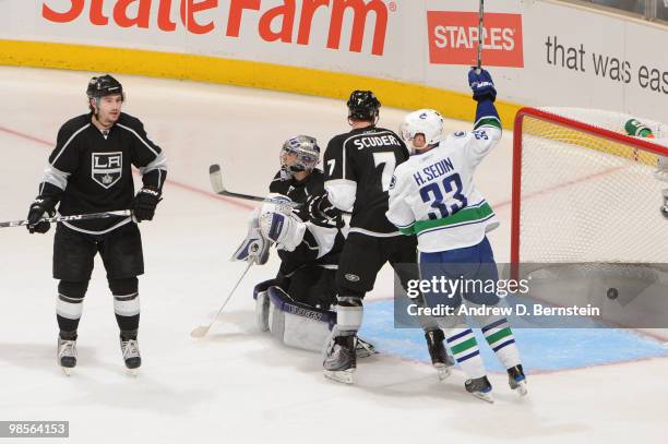 Henrik Sedin of the Vancouver Canucks reacts after a goal against Drew Doughty, Jonathan Quick and Rob Scuderi of the Los Angeles Kings in Game Three...