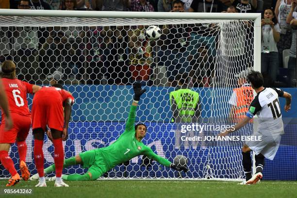 Costa Rica's midfielder Bryan Ruiz shoots a penalty leading to the Swiss goalkeeper scoring an own goal during the Russia 2018 World Cup Group E...