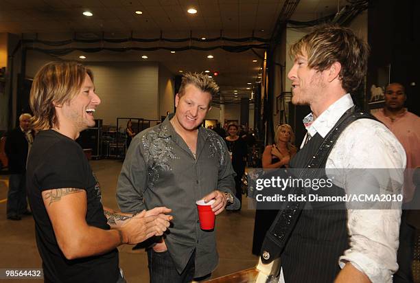 Musicians Keith Urban, Gary LeVox and Joe Don Rooney of Rascal Flatts speak backstage during Brooks & Dunn's The Last Rodeo Show at the MGM Grand...