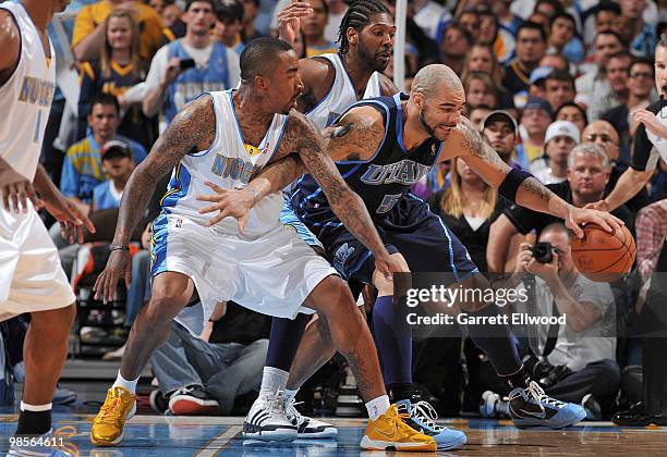 Carlos Boozer of the Utah Jazz goes to the basket against J.R. Smith and Nene of the Denver Nuggets in Game Two of the Western Conference...