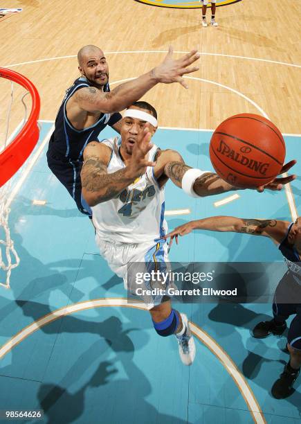 Kenyon Martin of the Denver Nuggets goes to the basket against Carlos Boozer of the Utah Jazz in Game Two of the Western Conference Quarterfinals...